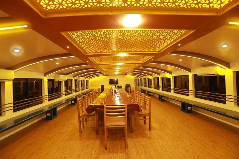 Massive upper deck banquet and conference hall with arched ceiling, perimeter seating, multiple AC units, and long dining table