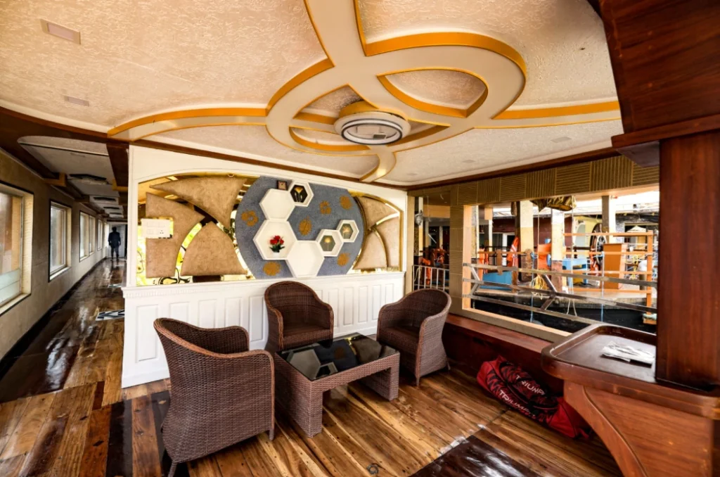Spacious open-concept living lounge with wicker chairs, designer ceiling, and water views